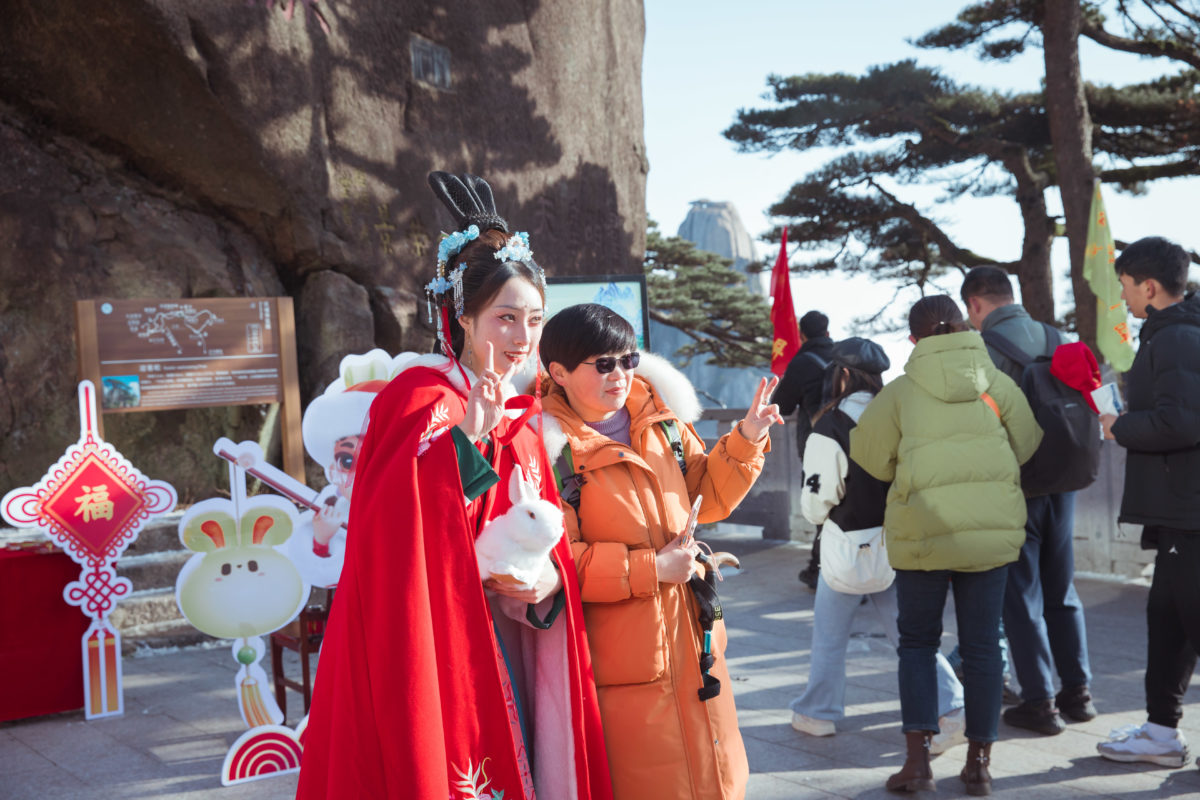 Tourists take photos at Mount Huangshan, a UNESCO world heritage site in China's eastern Anhui Province